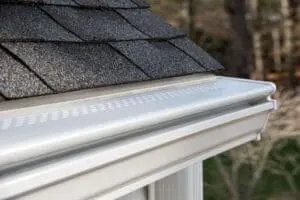 gutter guard cover on an asphalt shingle roof