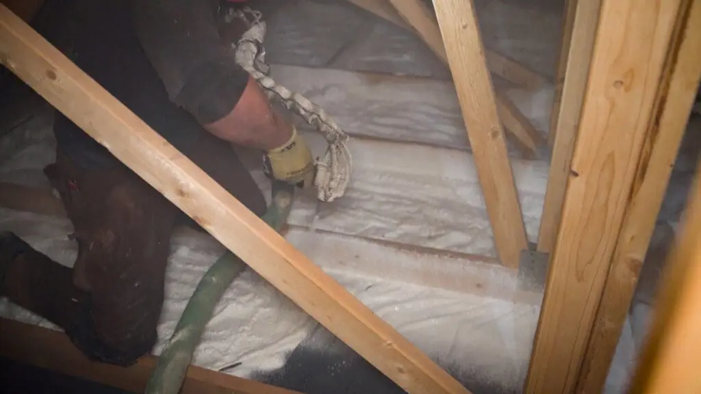 man installing spray foam insulation