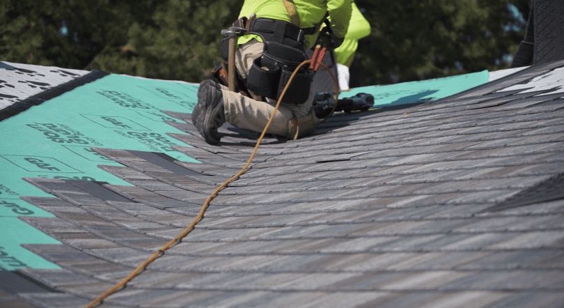 roofer installing synthetic shingles
