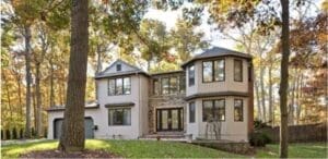 Gutter Installation Fitchburg, WI Tan house surrounded by woods
