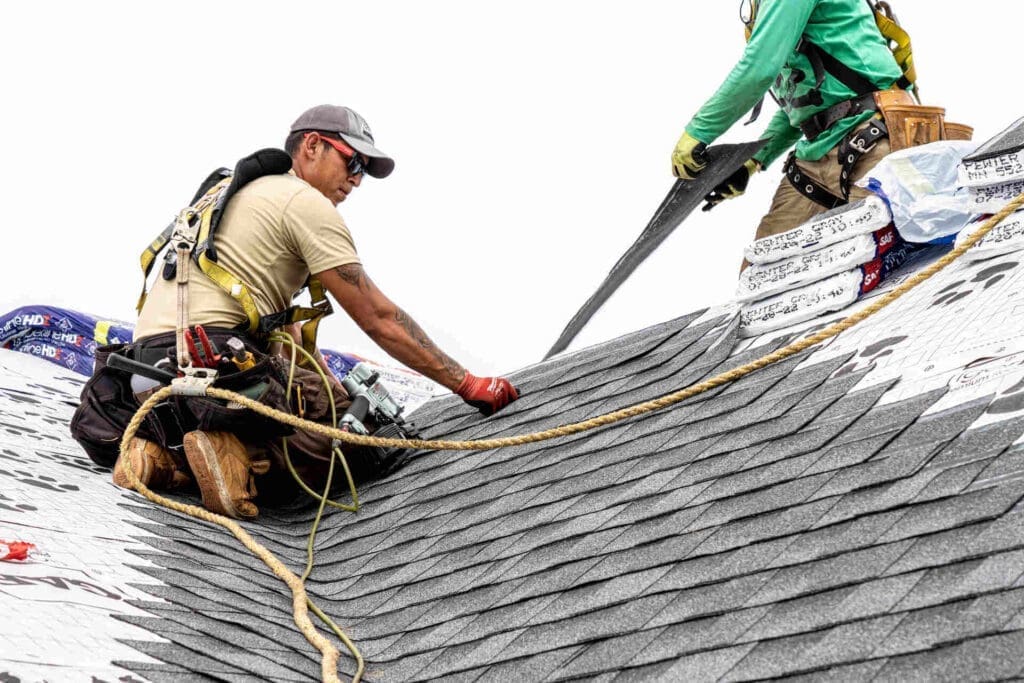 two men working on asphalt shingle roof