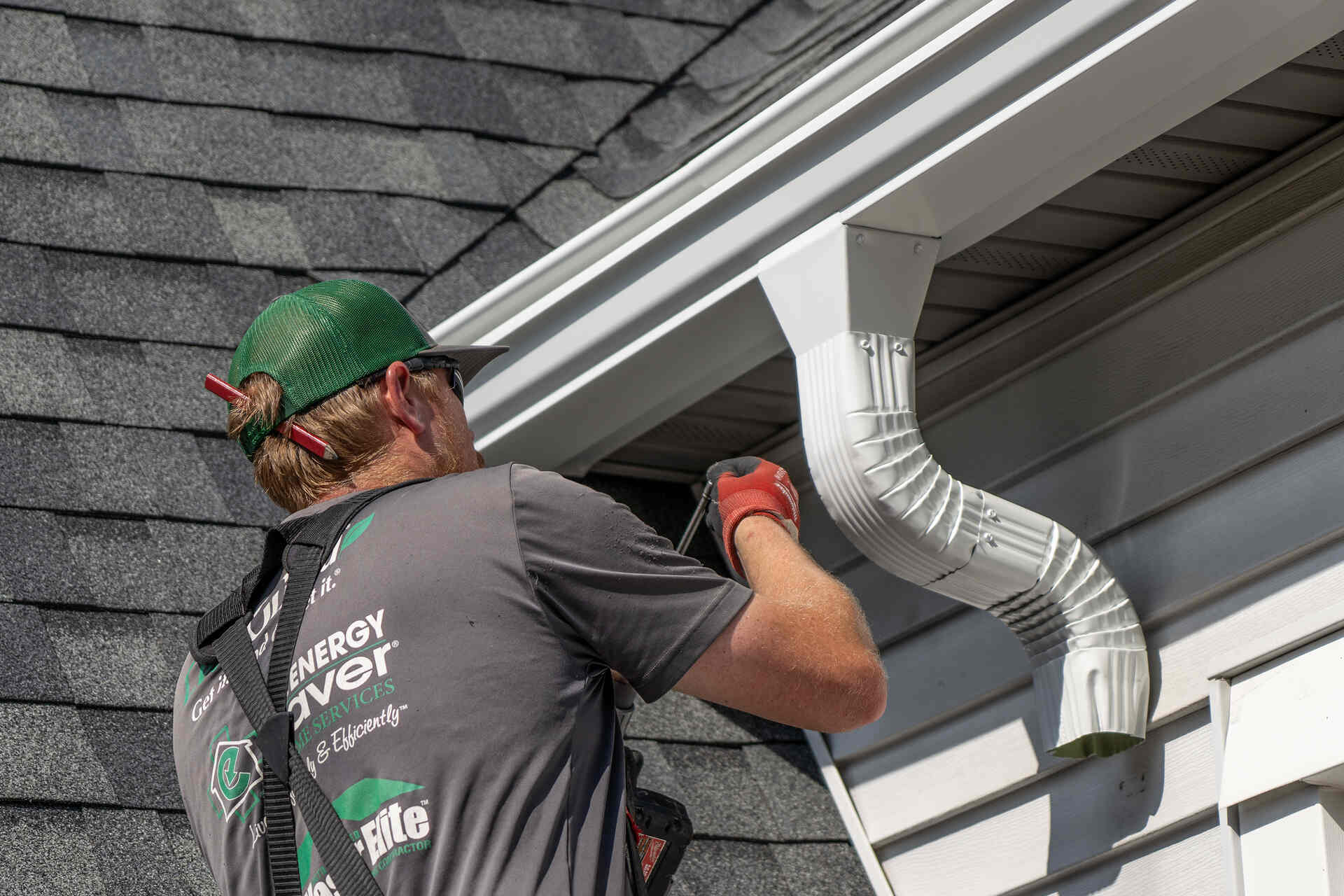 larson home services employee working on the gutters of a home