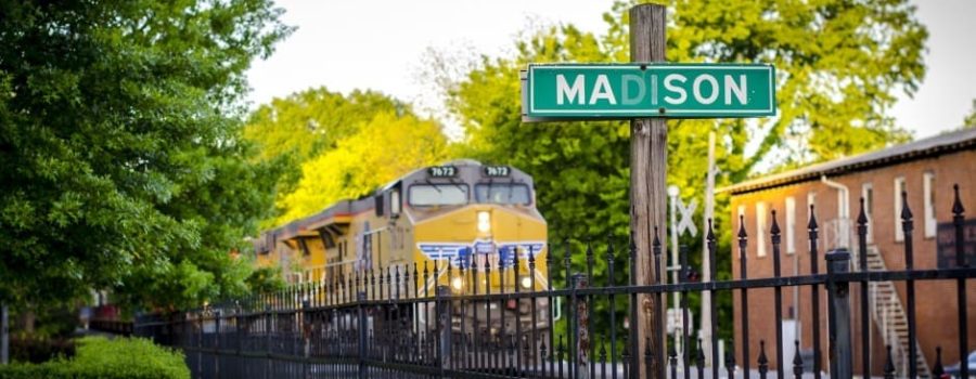 madison street sign with train in the background